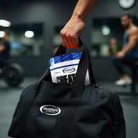 Image of a person’s hand retrieving Gaspari Nutrition Creatine from a gym bag, symbolizing convenience for fitness enthusiasts, with a blurred gym background.