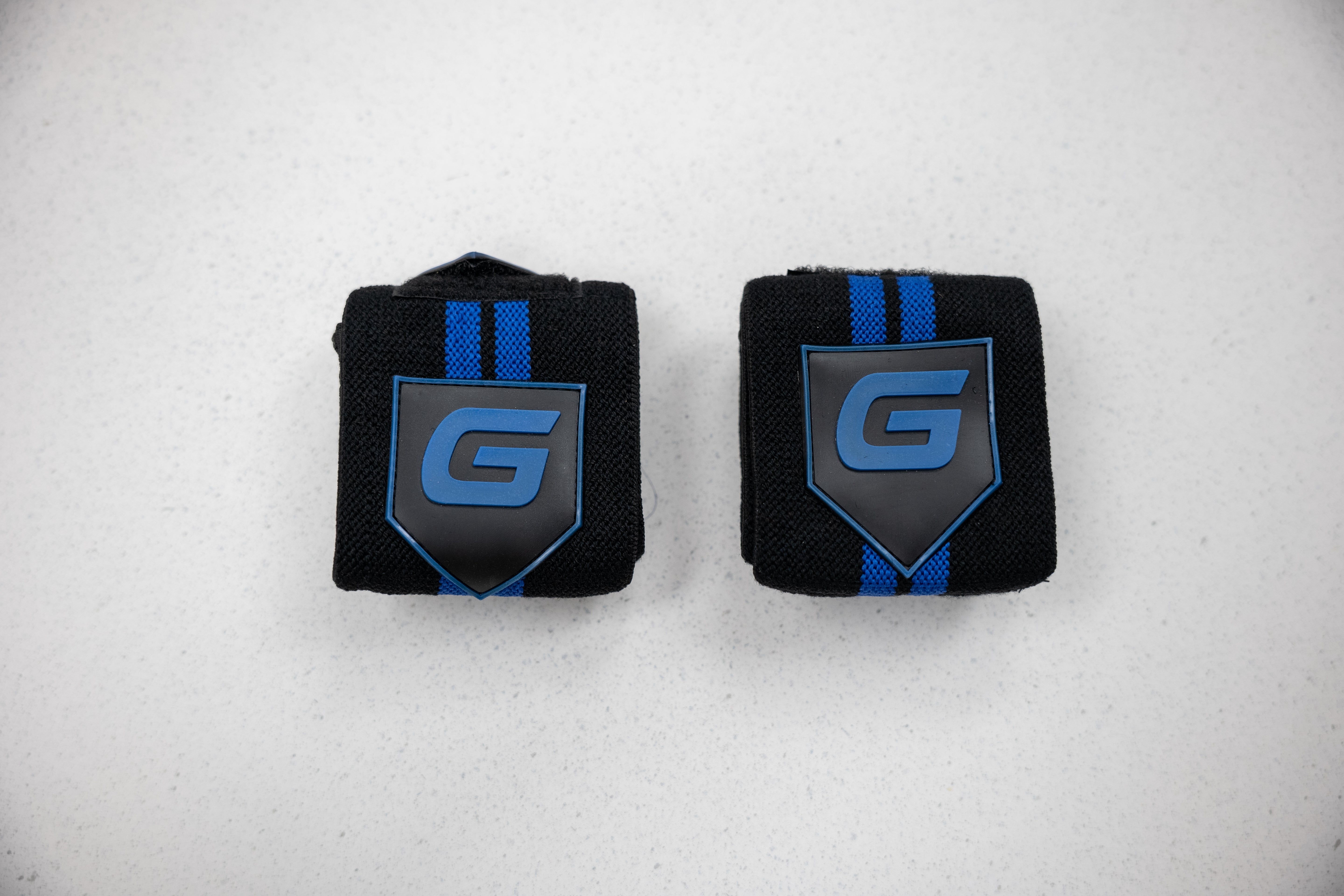 Gaspari Wrist Wraps featuring a black and blue design for enhanced wrist support during workouts.