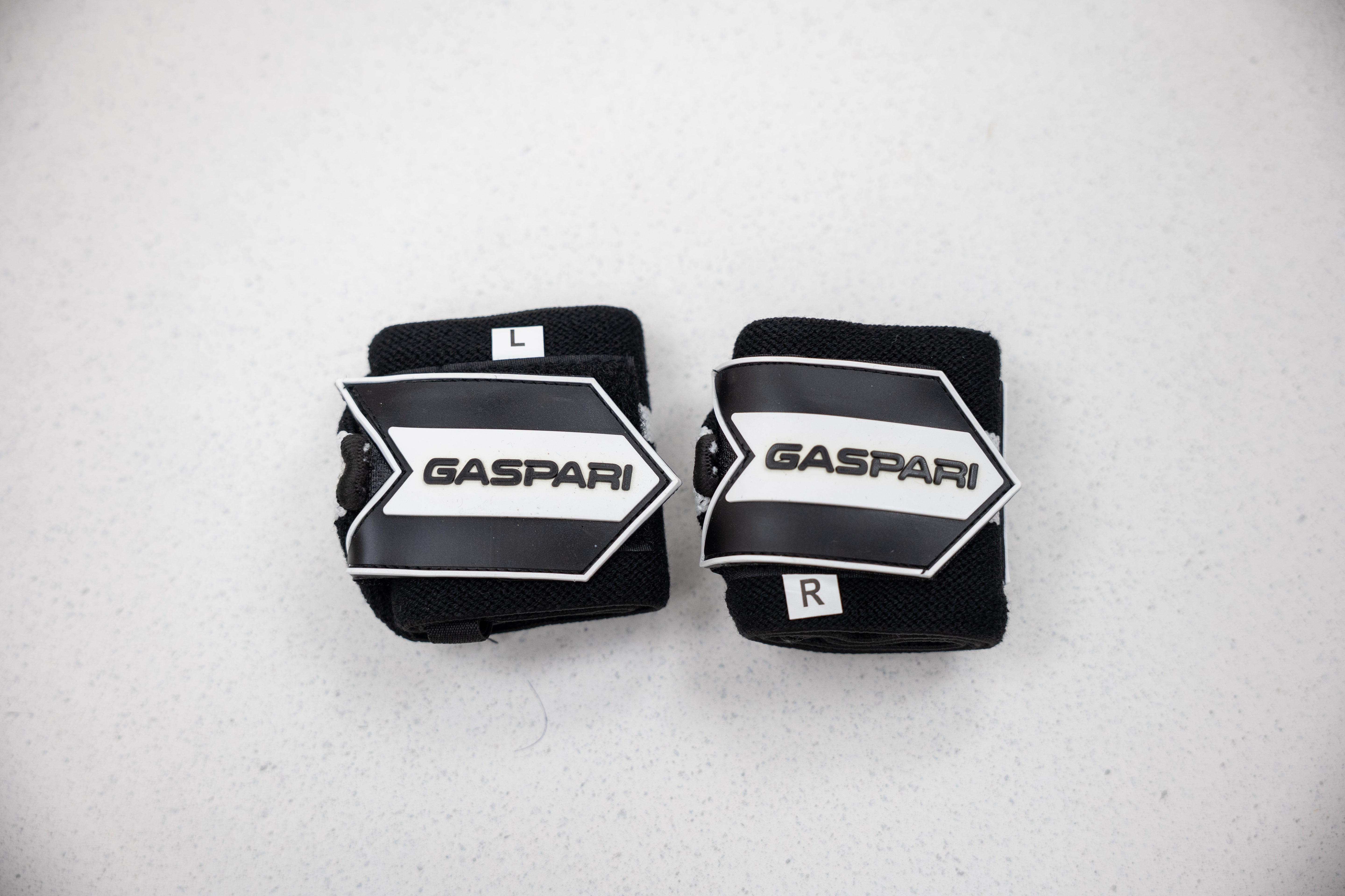 Gaspari Wrist Wraps labeled L and R for precise fit, offering support during heavy lifting.