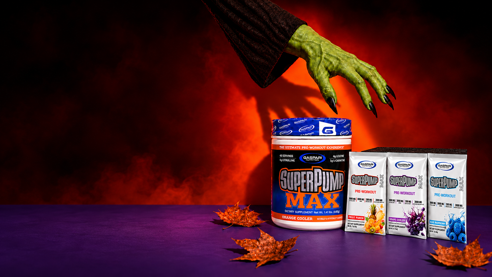 Green monster hand reaching toward SuperPump Max Orange Cooler and three sample packs